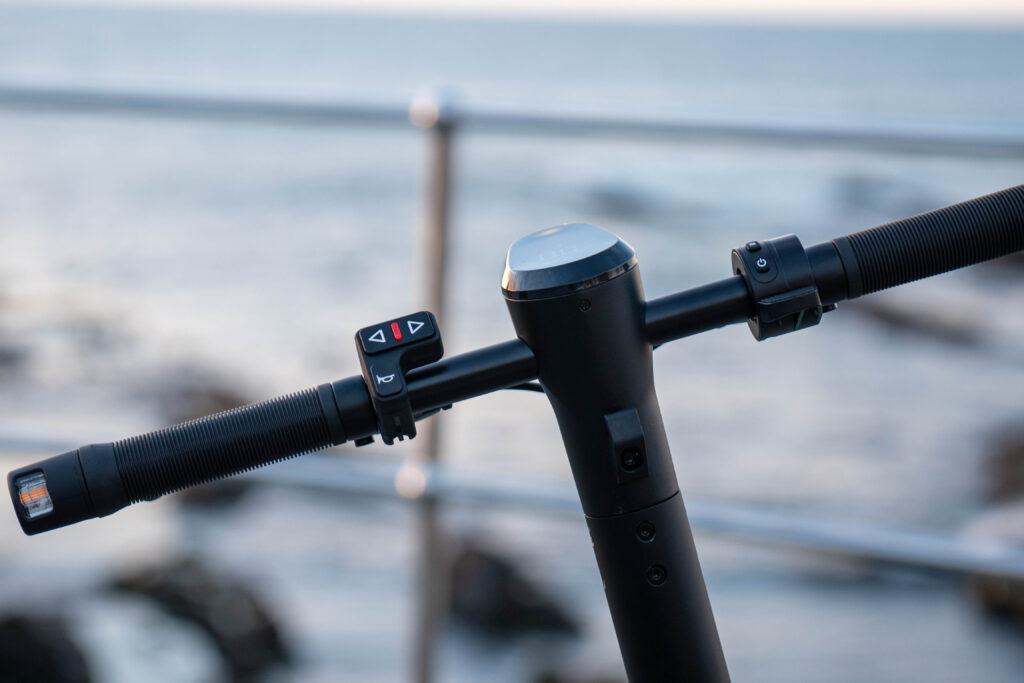 Close-up of a Speedbike scooter's handlebar with LCD display and control buttons